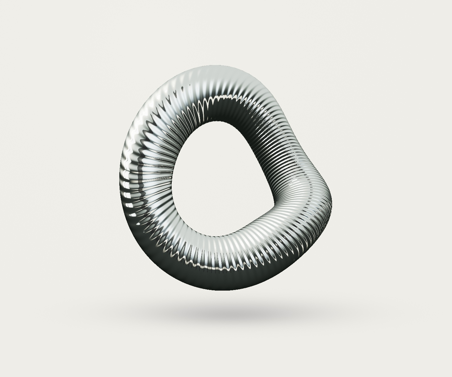A folded, finely ribbed metallic sculpture under warm studio light.